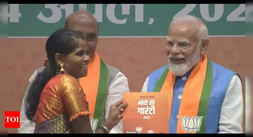 PM Narendra Modi presents manifesto to Bastar's daughter Neelavati Maurya | India News