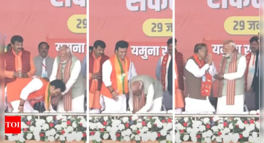 PM Modi stops BJP candidate from touching his feet, instead touches young leader's feet 3 times at Delhi rally | India News